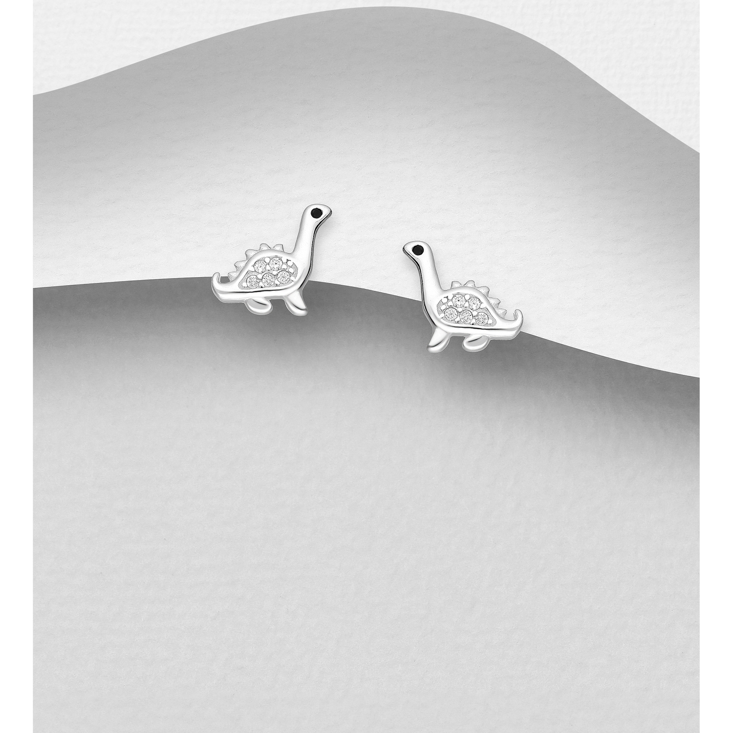 Sterling silver dinosaur earrings, on a grey display card