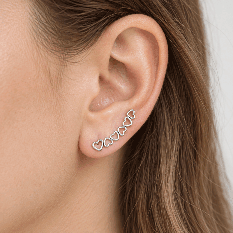 Sterling silver heart ear climber following the curve of the ear
