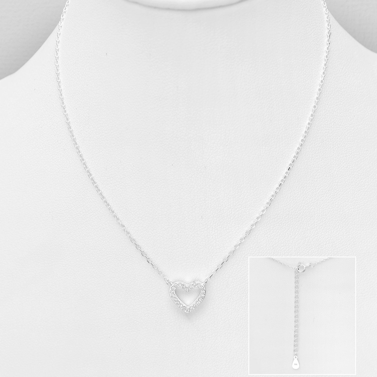 Sterling silver necklace with an open cubic zirconia heart pendant on a white display bust