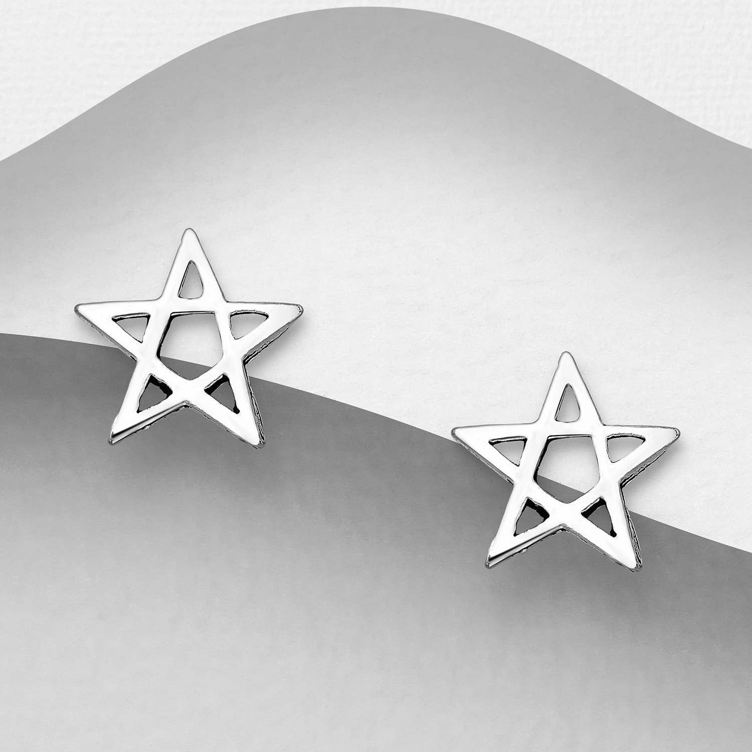 Sterling silver pentagram stud earrings, on a grey display card