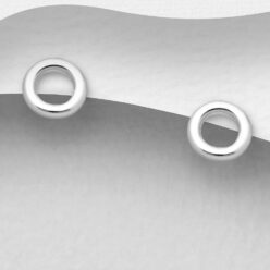 Sterling silver tiny circle stud earrings, on a grey display card