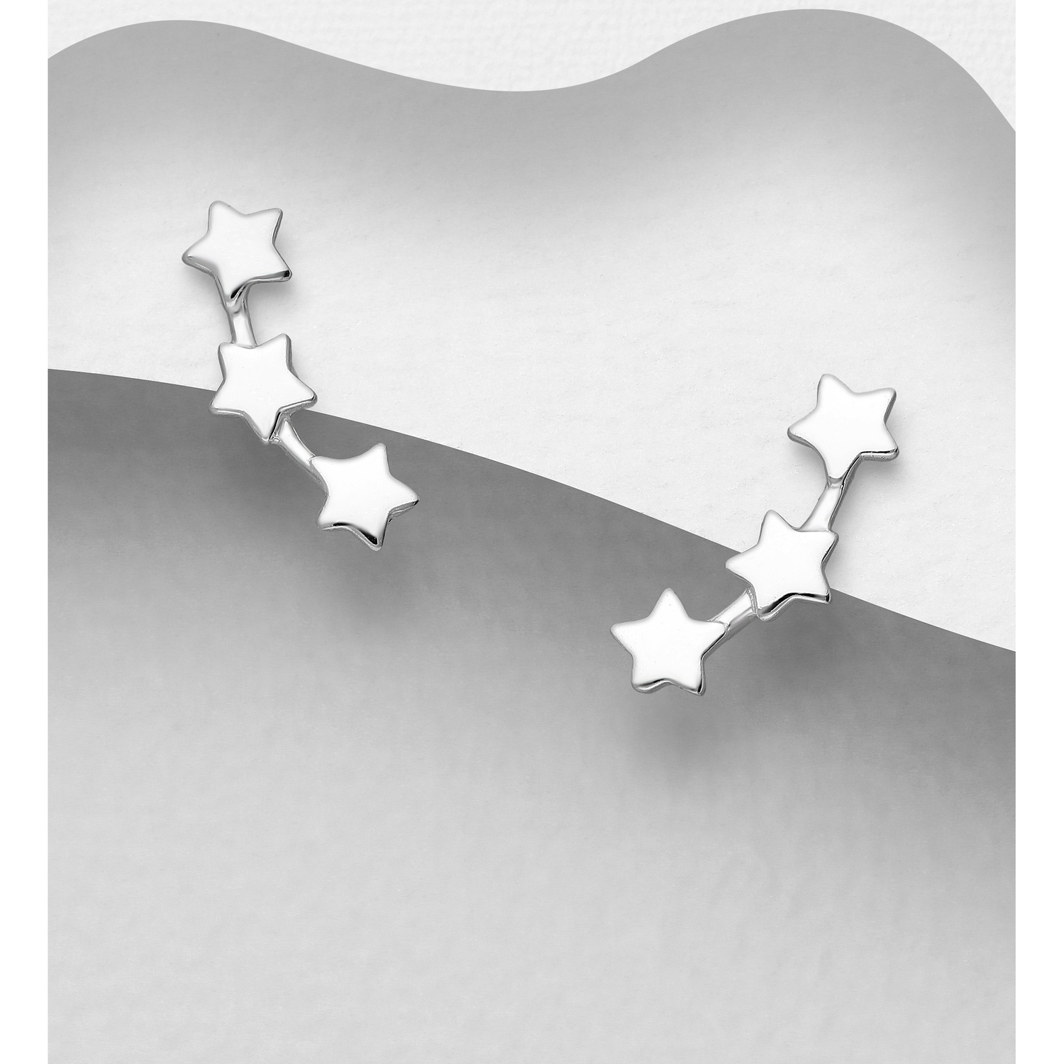 Sterling silver triple star stud earrings, on a grey display card