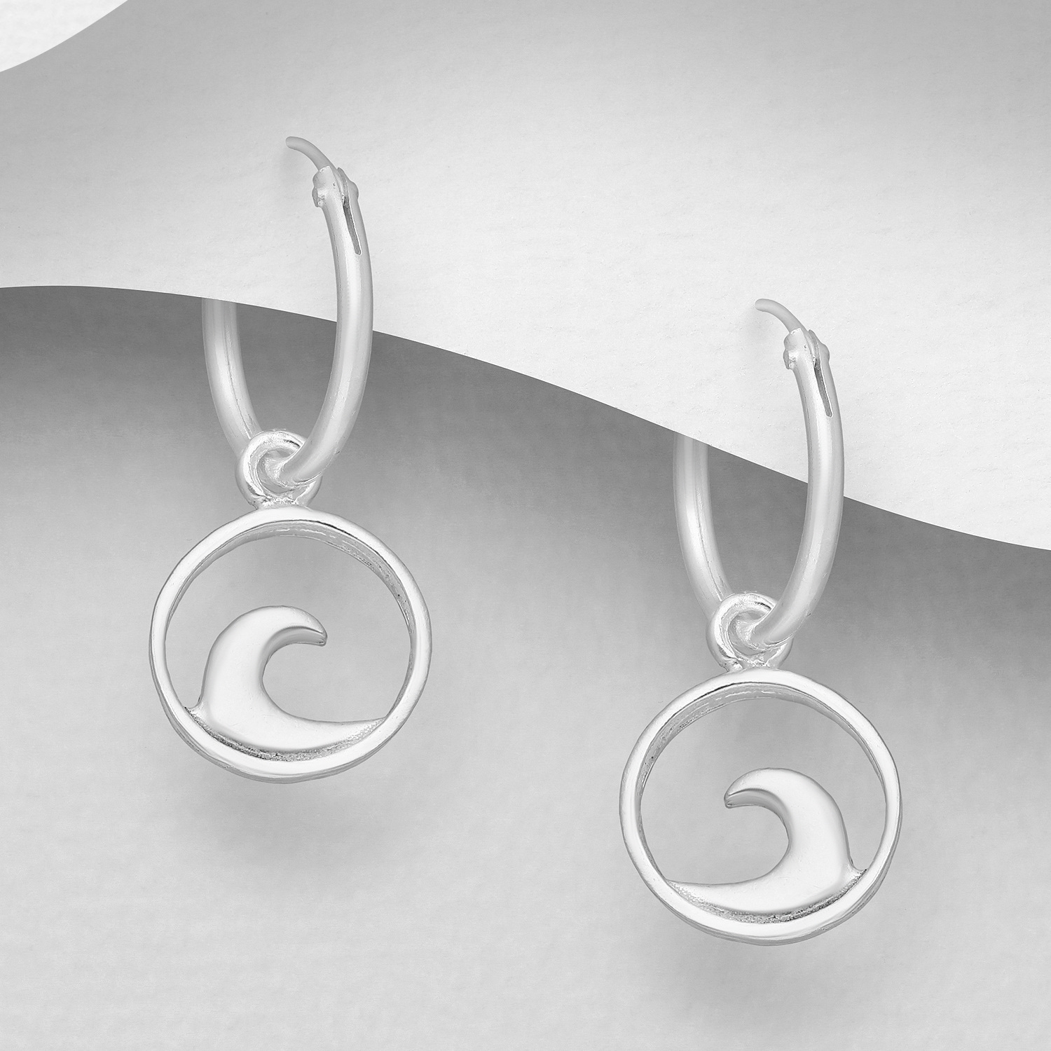Sterling silver wave hoop earrings (1.19cm), on a grey display card